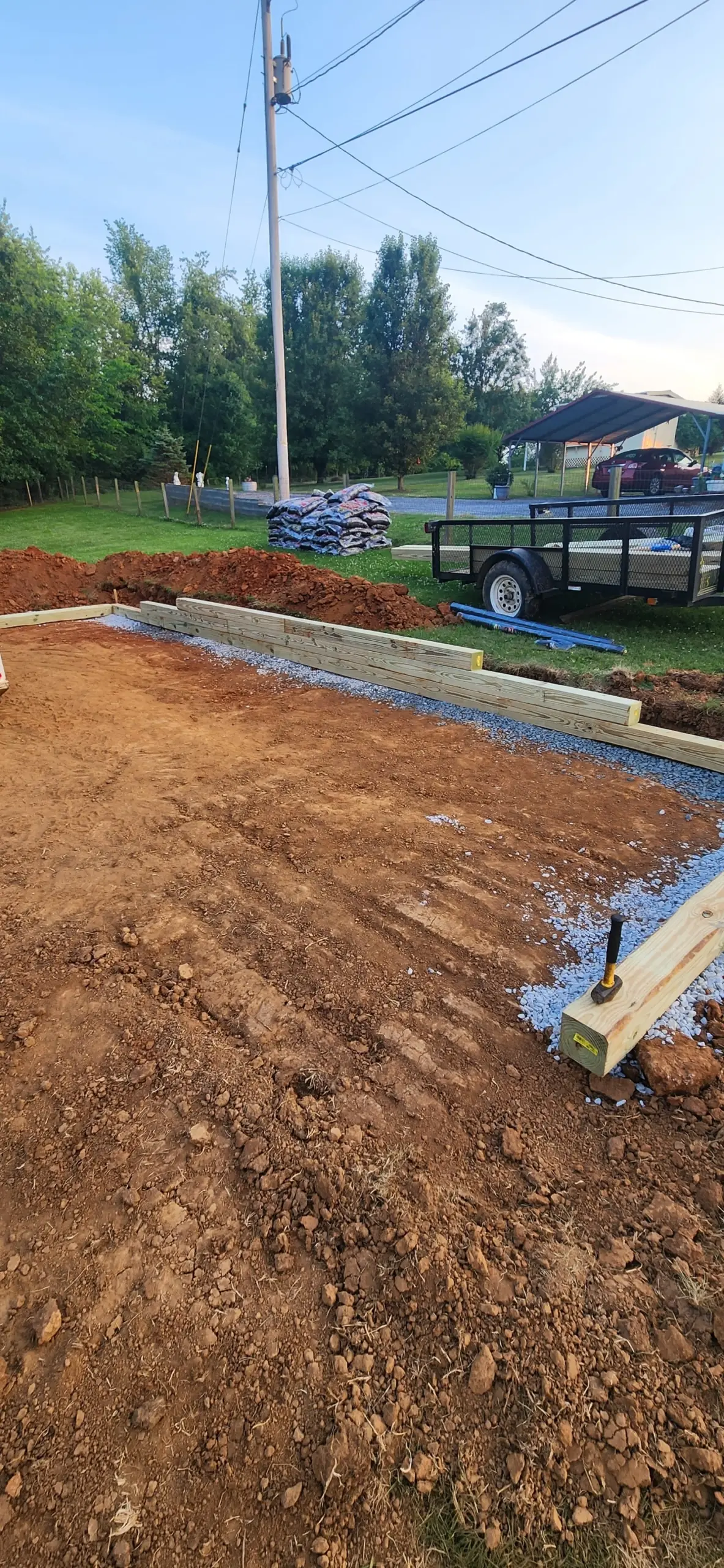 Leveled dirt pad framed with timbers for a backyard project