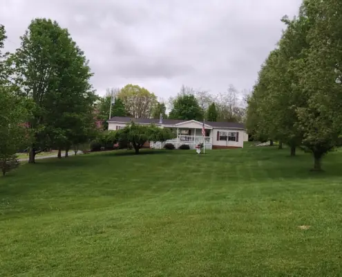 Freshly mowed lawn leading up to a white home