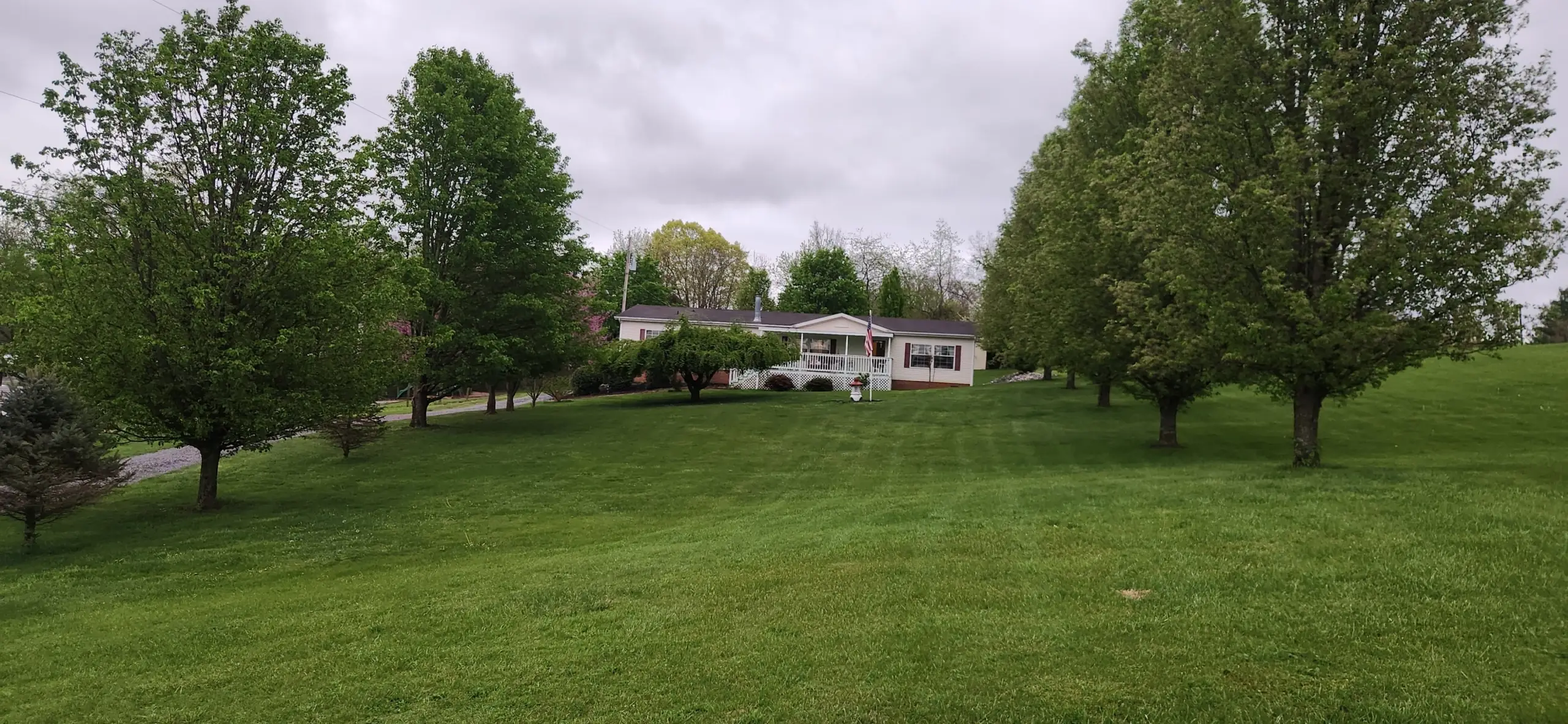 Freshly mowed lawn leading up to a white home