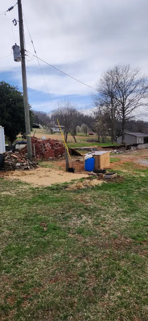 Cleared yard with a pile of salvaged bricks