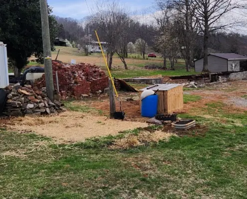 Cleared yard with a pile of salvaged bricks