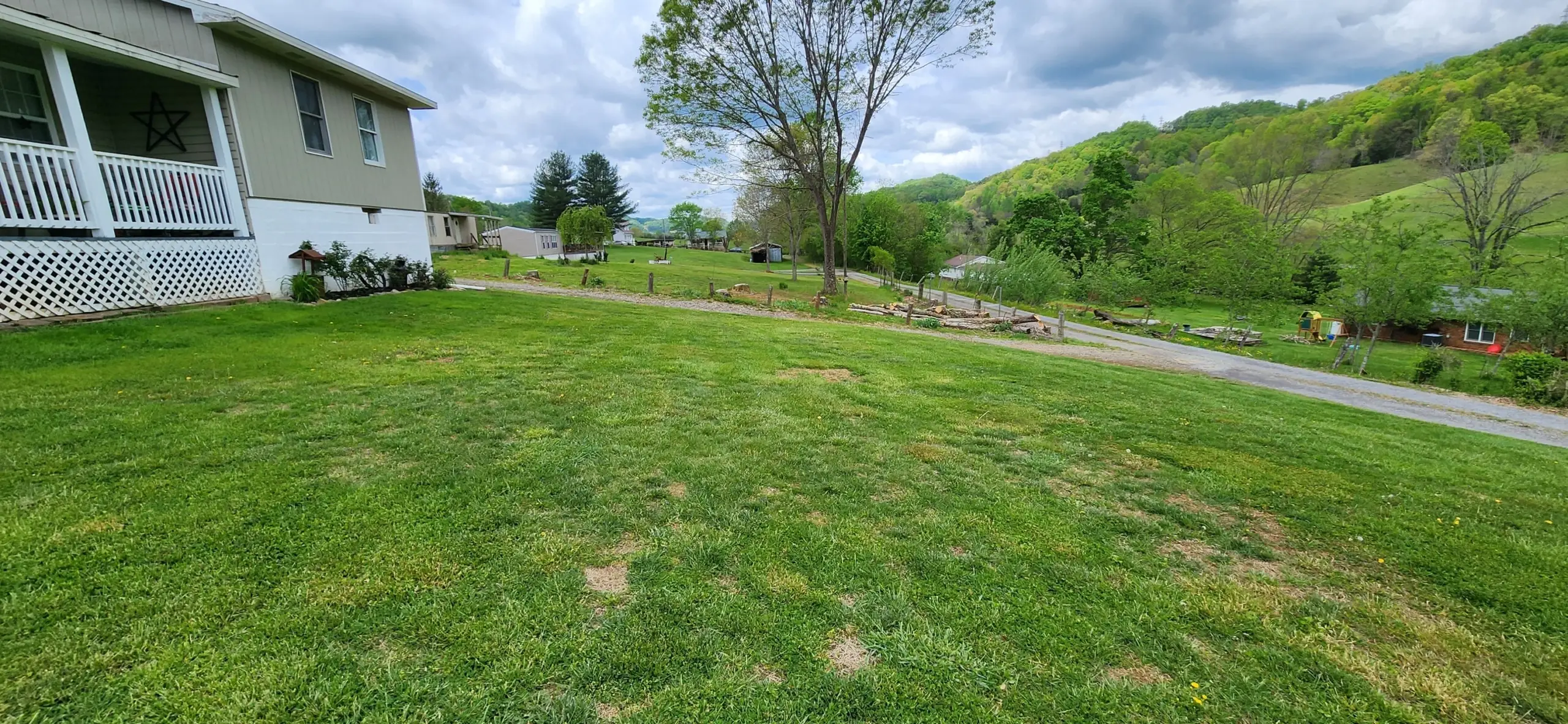 Freshly mowed side yard with a valley view