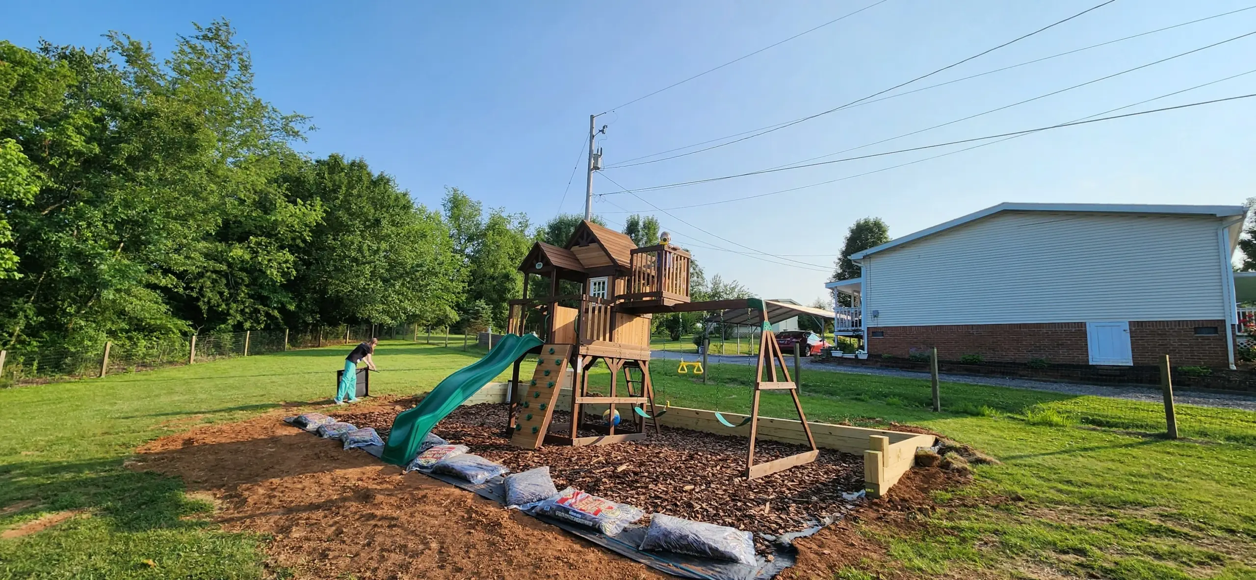 Wooden swing set installed on a new mulch play area